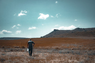 Rear view of man walking on land