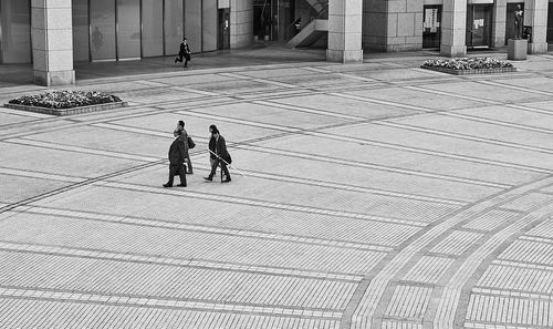 Rear view of people walking in city