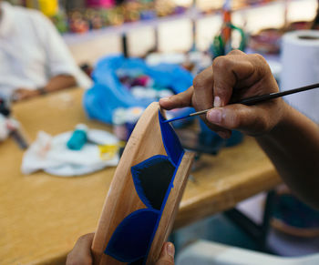 Mexican artist painting pottery