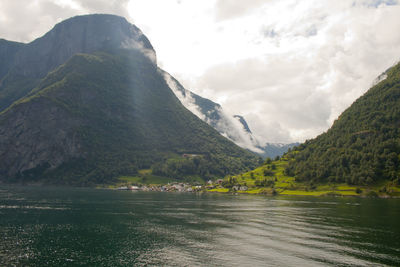 Scenic view of lake and mountains against sky