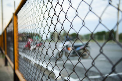 Close-up of chainlink fence against sky