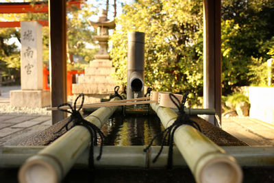 Fountain by street against building