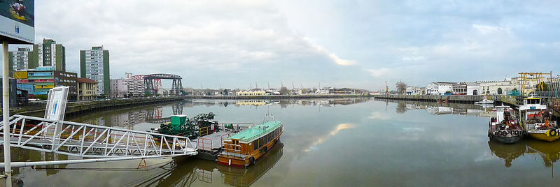 View of harbor against cloudy sky