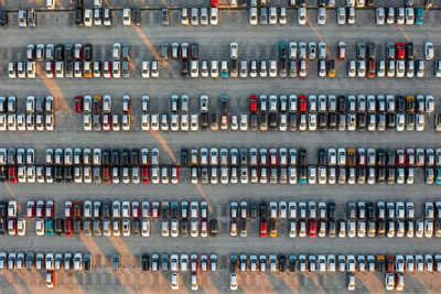 Aerial view of brand new cars at the logistics center, near the factory. car parking lot.