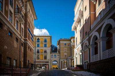 Low angle view of buildings against blue sky