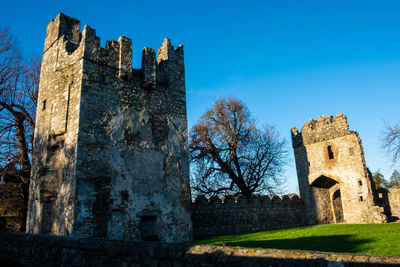 Low angle view of historic building against blue sky