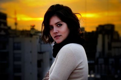 Portrait of woman standing against sky during sunset