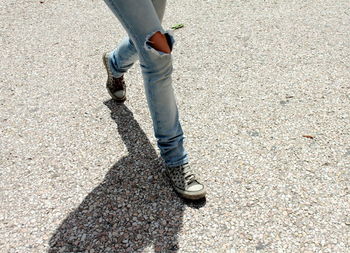 Low section of person walking on street