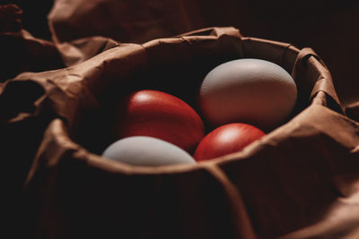 High angle view of easter eggs with tomatoes in bowl