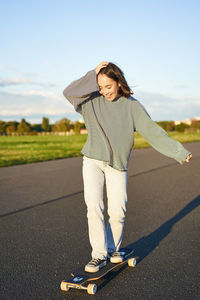 Full length of woman standing on road