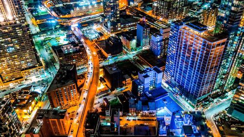 High angle view of illuminated buildings in city at night