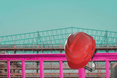 Close-up of red metallic structure against clear sky