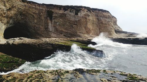 Waves splashing on rock formation