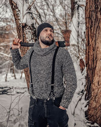 Young man standing on snow covered land