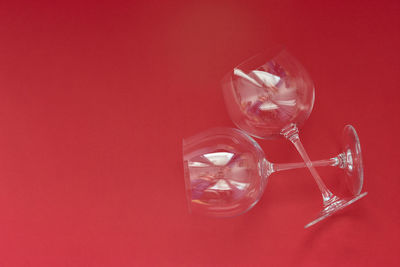 Empty wine glasses lies on a red background. valentines day concept.