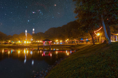 Scenic view of lake against sky at night