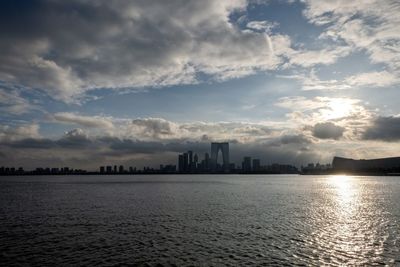 Scenic view of sea by buildings against sky