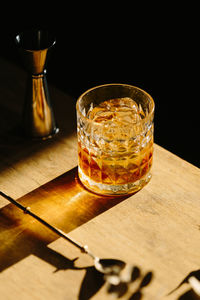 Close-up of glass with bourbon whiskey on table