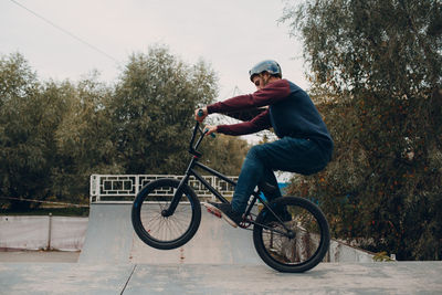 Man with bicycle at park