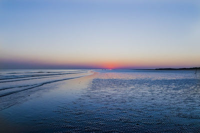 Scenic view of sea against clear sky during sunset