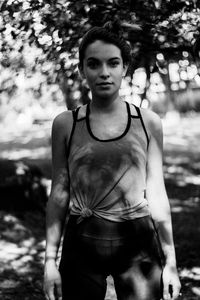 Portrait of teenage girl exercising in park