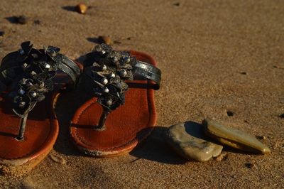 Close-up of footwear on sand