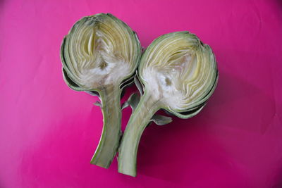 Close-up of sliced artichoke on pink background