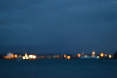 Illuminated sea against sky at night