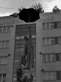 Low angle view of statue against building