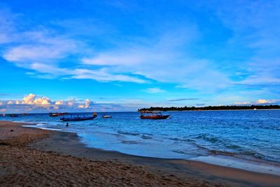 Scenic view of beach against blue sky