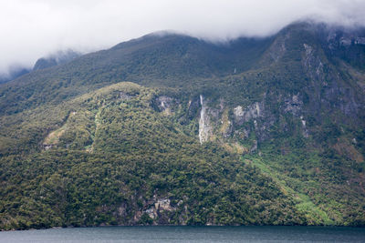 Scenic view of sea and mountains against sky