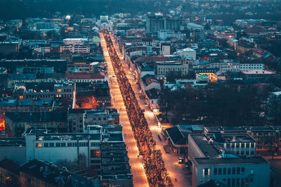 High angle view of illuminated street amidst buildings in city