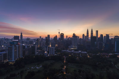 Panoramic view of buildings in city against sky during sunset