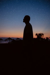 Silhouette man standing against sky