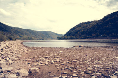 Scenic view of lake against cloudy sky