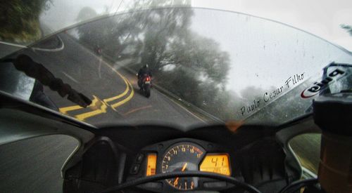 Close-up of car moving on road