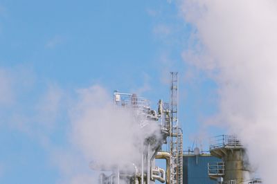 Low angle view of smoke stack against sky