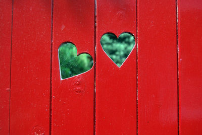 Close-up of heart shape on red wall