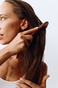 Close-up of young woman against white background