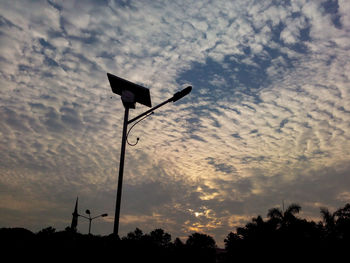 Low angle view of silhouette street light against sky at sunset