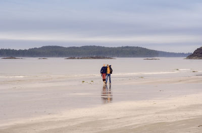 Teenagers walking on beach