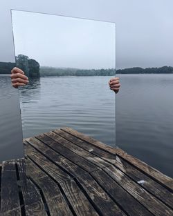 Scenic view of pier on lake against sky
