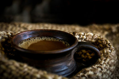 Close-up of coffee cup in sack