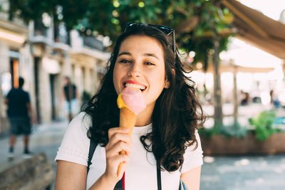 Portrait of young woman eating ice cream