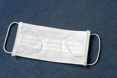 High angle view of eyeglasses against blue background