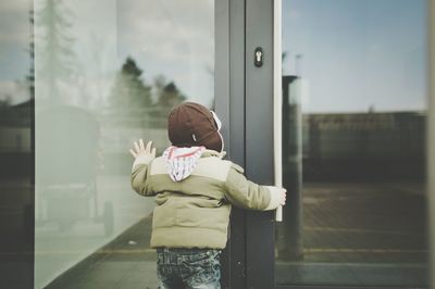 Rear view of boy in city