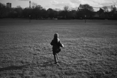 Full length of woman walking on field