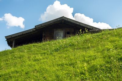 House on field against sky