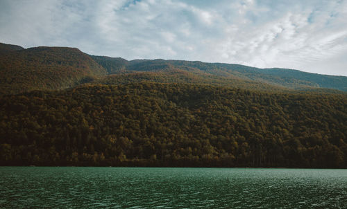 Scenic view of lake and mountains against sky