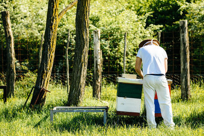 Rear view of man working on field